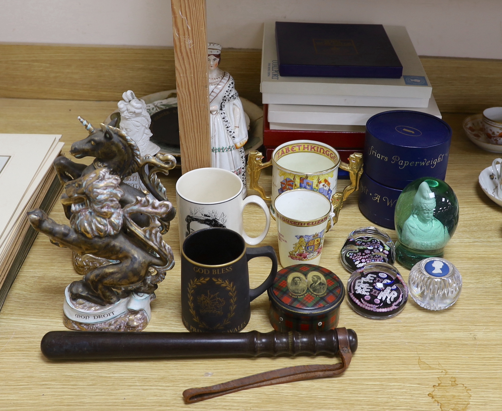 A collection of principally Victorian and later commemorative wares to include a pair of Wedgwood porcelain armorial beasts, glass paperweights etc together with a constabulary truncheon, the largest 39cm in length